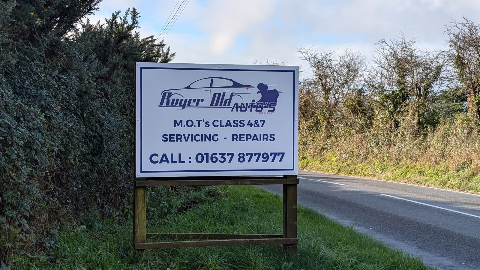 Roger Old Auto's roadside sign: MOTs Class 4 and 7, servicing, repairs, call 01637 877977